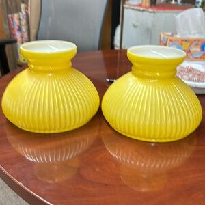 Milk glass yellow lamp shades used on oil lamps.